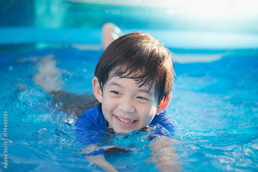 Boy swimming and playing in a pool Boy swimming and playing in a pool