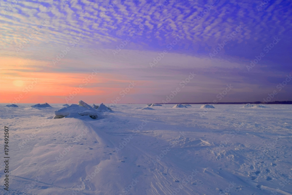 Winter sunset over frozen lake in Siberia.