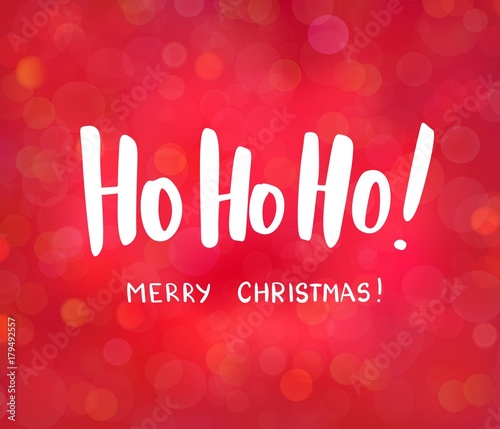 Ho-ho-ho and Merry Christmas text, hand drawn lettering. Blurred background with bokeh effect. Great for Christmas, New year cards, posters, gift tags.