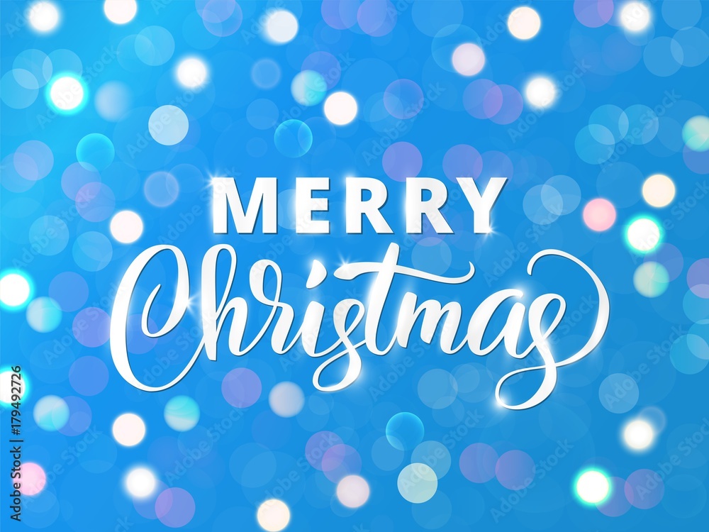 Merry Christmas text. Holiday greetings quote. White and blue sparkling glowing lights. Background with bokeh effect.
