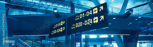 Gates D and E. Sign in airport. Interior of the airport..