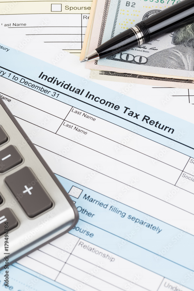 Tax form with calculator, pen, and dollar banknote; document are mock-up Tax form with calculator, pen, and dollar banknote; document are mock-up