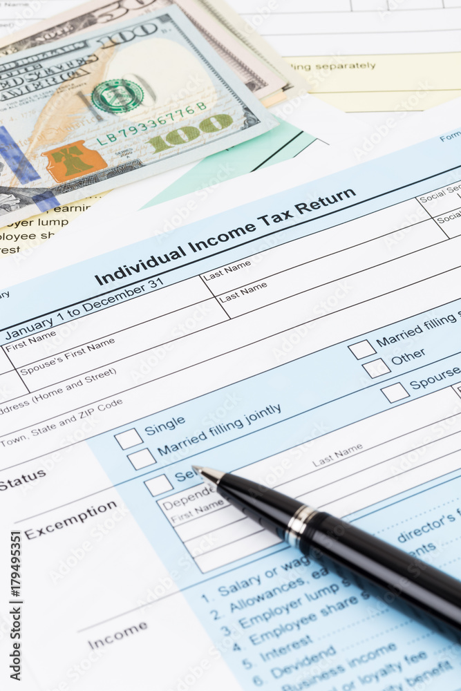 Tax form with pen, and dollar banknote; document are mock-up Tax form with pen, and dollar banknote; document are mock-up