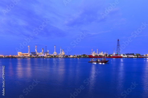 Oil refinery on water front at twilight
