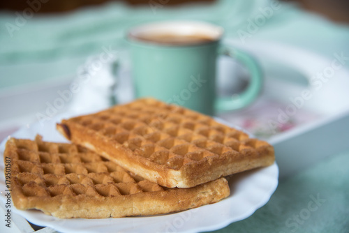 Waffles, coffee and milk in cow shaped container