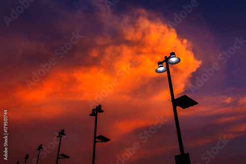 Lamp post silhouette with sunset sky.