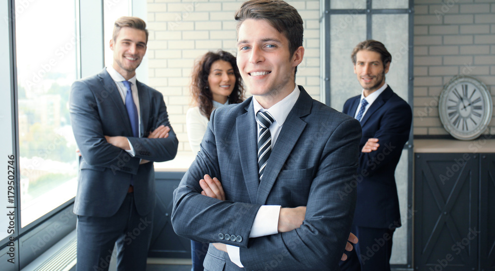 Businessman with colleagues in the background in office. Businessman with colleagues in the background in office.