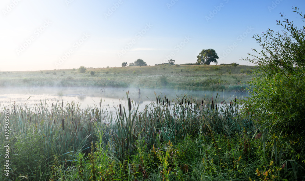 Foggy summer landscape.River Upa in Tula region,Russia.Mist over the water.Morning calm.