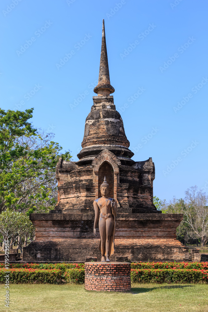 Fototapeta premium Pagoda at Wat Sa Si and walking Buddha statue, Shukhothai Historical Park, Thailand