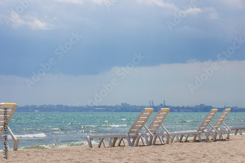 chaise lounge on the sandy beach and a view of the horizon © stason4ik