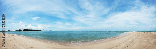 Tropical beach panorama with blue sky and clouds in summer season.