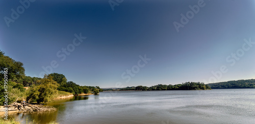 Panoramic view of a lake formed by a marsh called Cecebre in Galicia (Spain) with vegetated banks, mainly trees