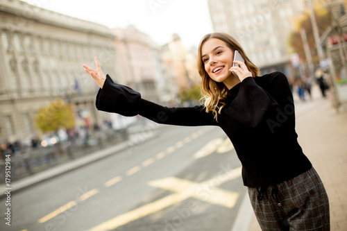 Young woman waiting for tax...