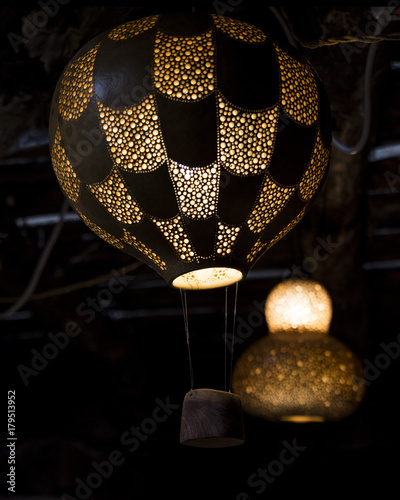handmade pumpkin lamps, drilled with various measures to create drawings and light games, made by a craftsman of Belvì, Sardinia photo