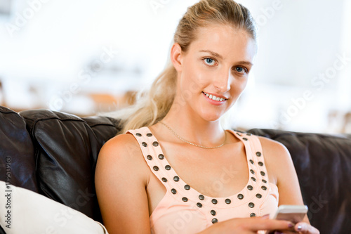 Portrait of young woman holding phone Free Download Portrait of young woman holding phone - GFXLoad