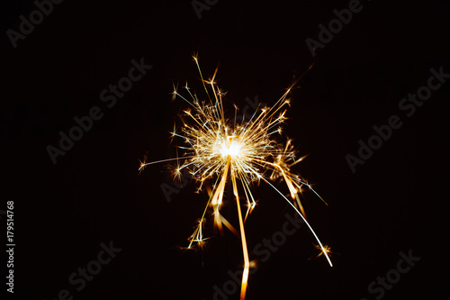 Light sparkles Bengal lights on a black background isolated