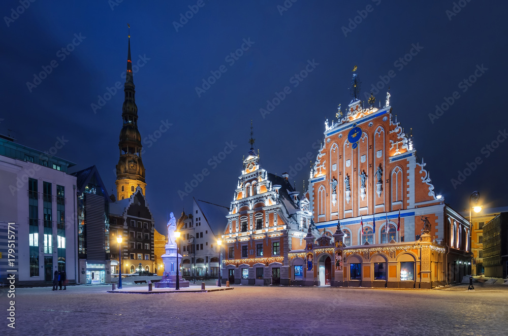 House of Blackheads in the Town Hall Square and the spire of the Cathedral in the historic center of the old city against background of night sky. Riga, Latvia