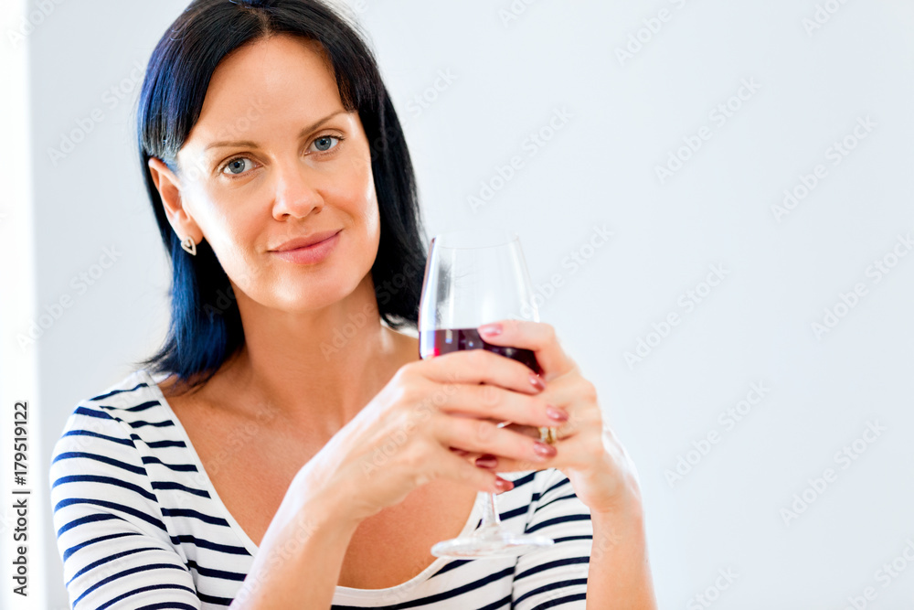Beautiful young woman holding glass with red wine Beautiful young woman holding glass with red wine