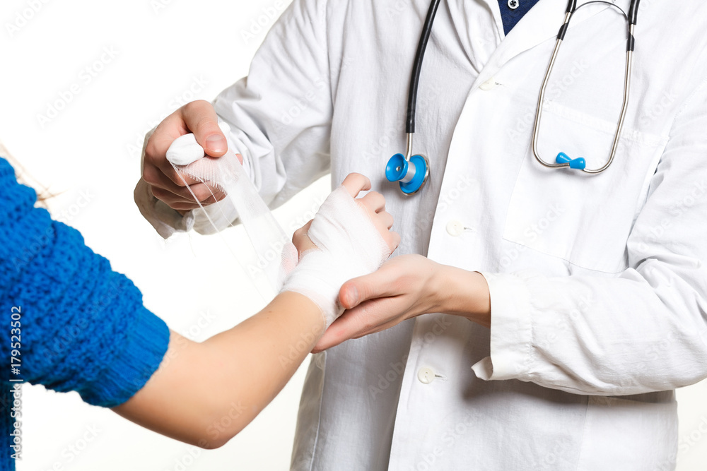 beautiful young doctor in a dressing gown with a stethoscope on a white background in the studio, wound dressing, bandage, first aid, beautiful young doctor in a dressing gown with a stethoscope on a white background in the studio, wound dressing, bandage, first aid,