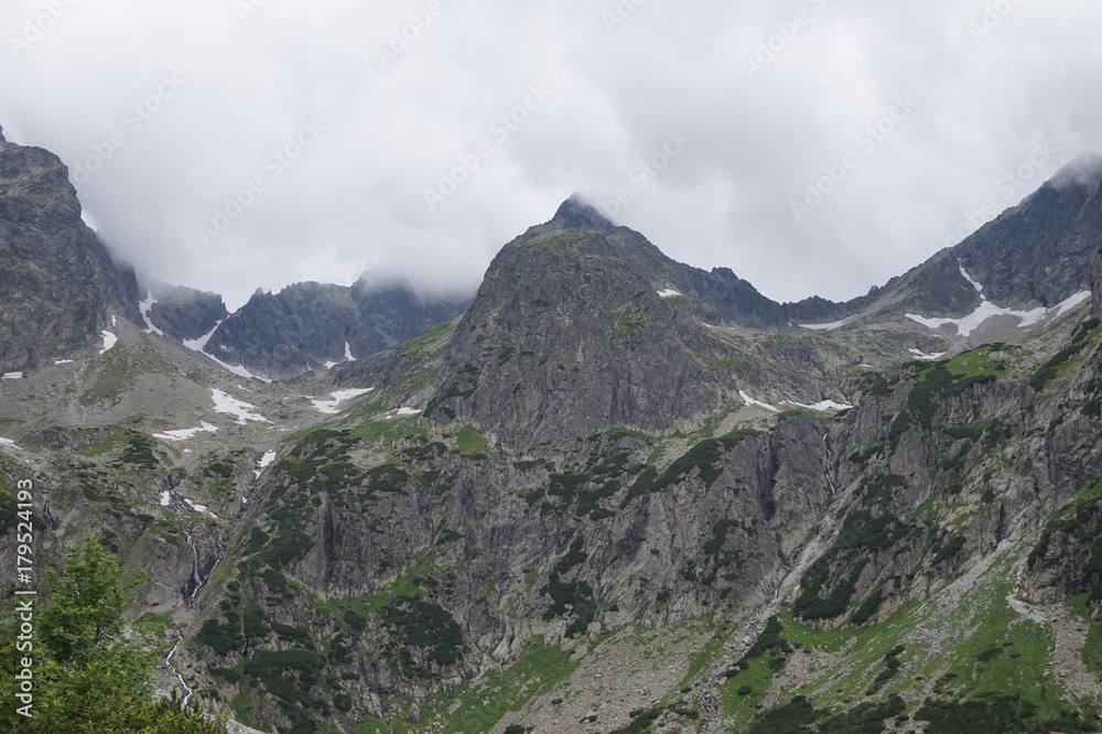 Fototapeta premium Nature in High Tatras in Slovakia. Mountains of rocky rocks cliffs and waterfalls suitable as background pictures of wishes, banners.