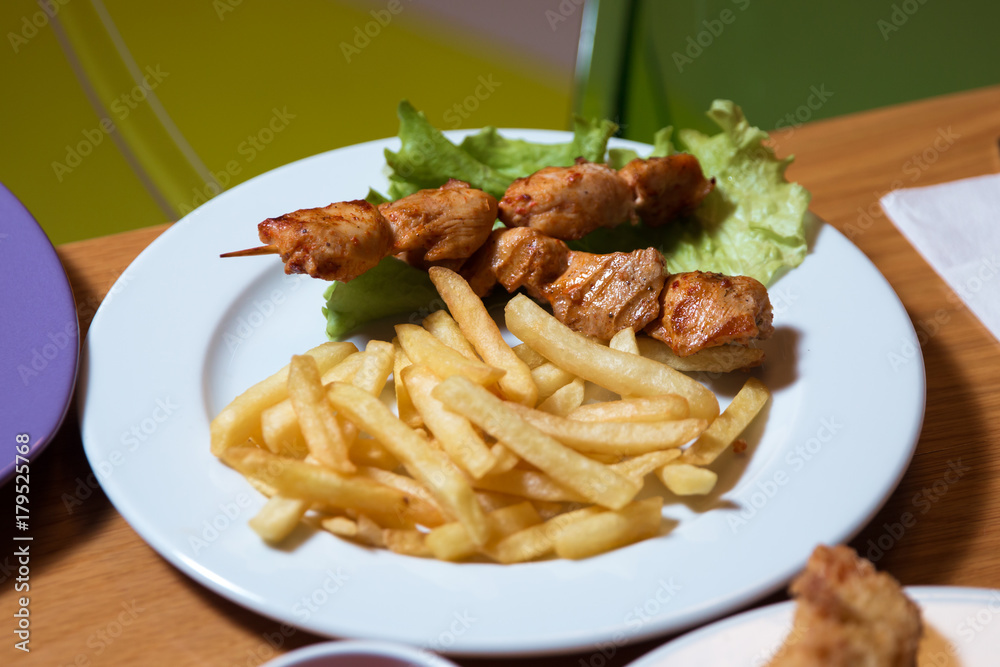 Chicken kebab with cartilage fry in the plate . Grilled chicken on bamboo skewers, close up view. Cartoon Chicken kebab with cartilage fry in the plate . Grilled chicken on bamboo skewers, close up view. Cartoon