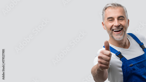 Smiling repairman giving a thumbs up photo