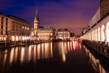 Town hall of Hamburg in Germany during twilight, reflection of light on water in canal