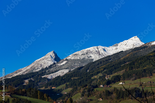 sunny mountain panorama in late autumn with first snow and bue sky photo