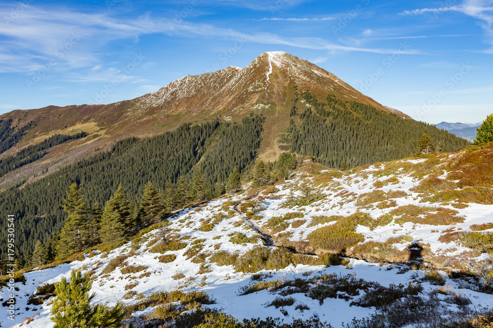 alpine panorama in late autumn with first snow and blue sky