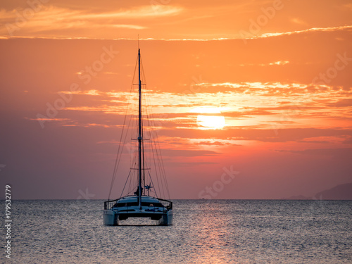 Sailing Boat and Catamaran at Sunset