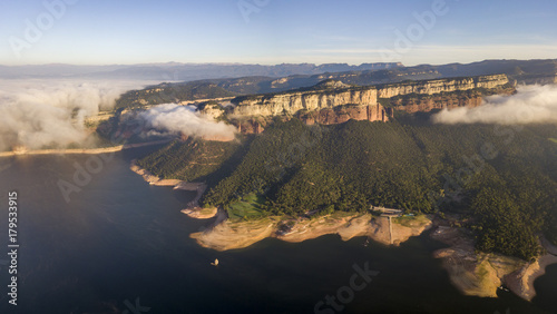 Aerial view of colorful sheer cliffs above Sau reservoir near Tavertet in Catalonia, Spain
