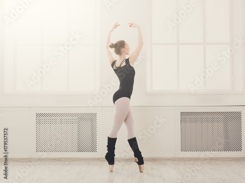 Beautiful ballerina stands in ballet croise