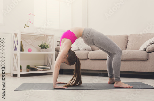 Woman training yoga in table top pose.