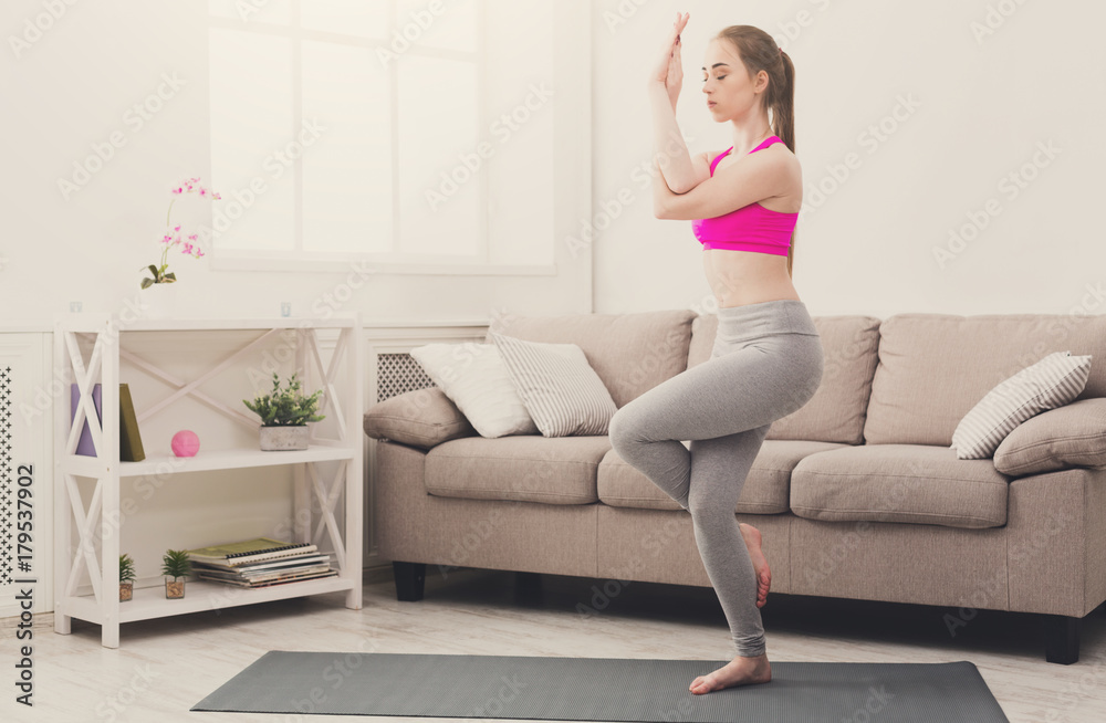 Woman training yoga in eagle pose. Woman training yoga in eagle pose.