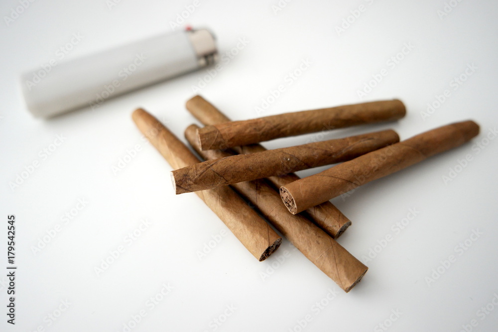 A bunch of tobacco with a lighter in the background