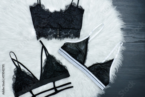 Stampa su tela Fashionable concept, three black lace bodices on white fur, top view