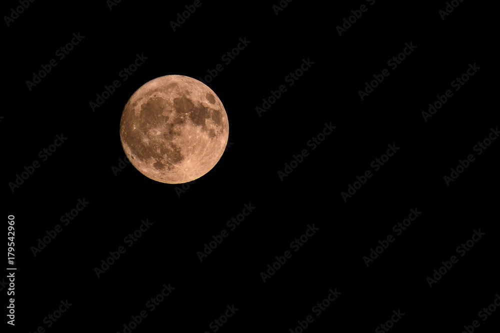 Full moon over dark black sky at night Full moon over dark black sky at night