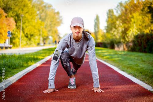 Young Healthy fitness woman runner stretching legs before running © zeljkomatic76