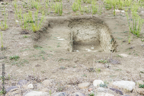 View of an empty grave ground. Open dumping. Religious place. Daylight.