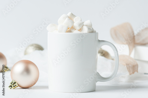 Fototapeta mug of hot chocolate with marshmallows surounded by Christmas decorations