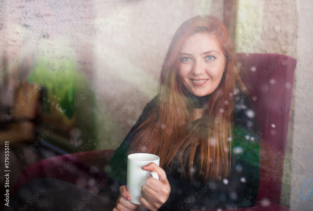 Beautiful girl drinking coffee at the coffee shop