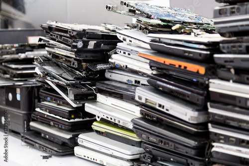 Canvas Print Stack of old, broken and obsolete laptop computer for repair