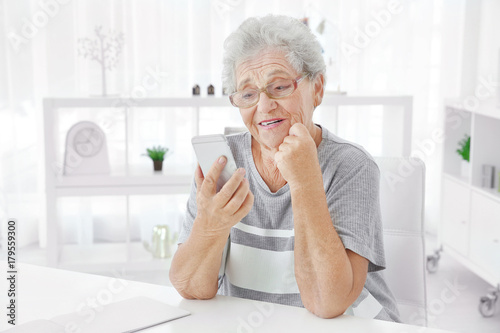 Elderly woman using cell ph...