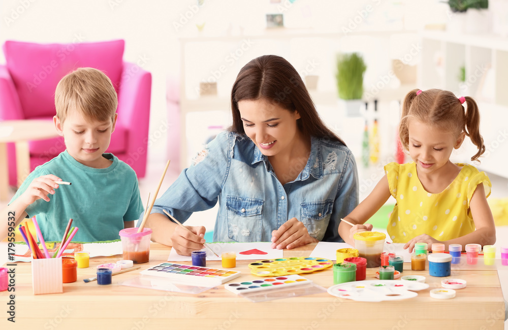 Happy family painting pictures at table indoors Happy family painting pictures at table indoors