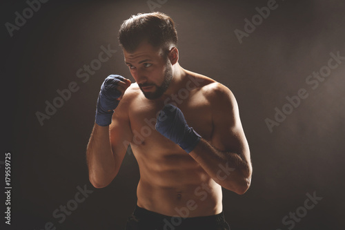 Male boxer on dark background