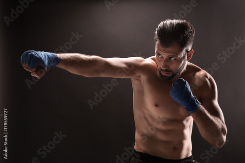 Male boxer on dark background