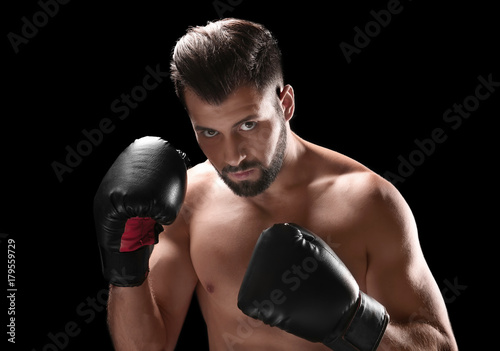 Male boxer on dark background © Africa Studio