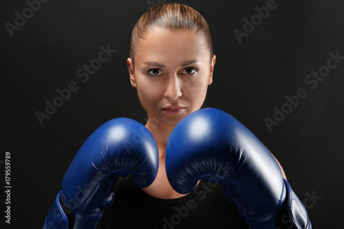 Female boxer on dark background