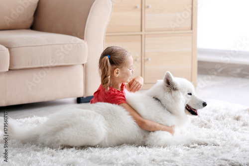 Cute little girl with dog a...
