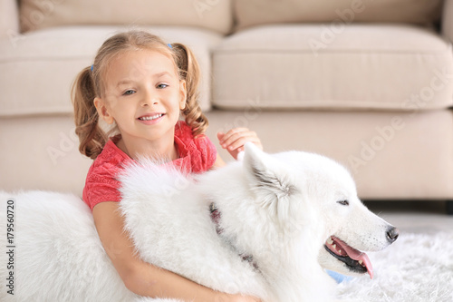Cute little girl with dog a...
